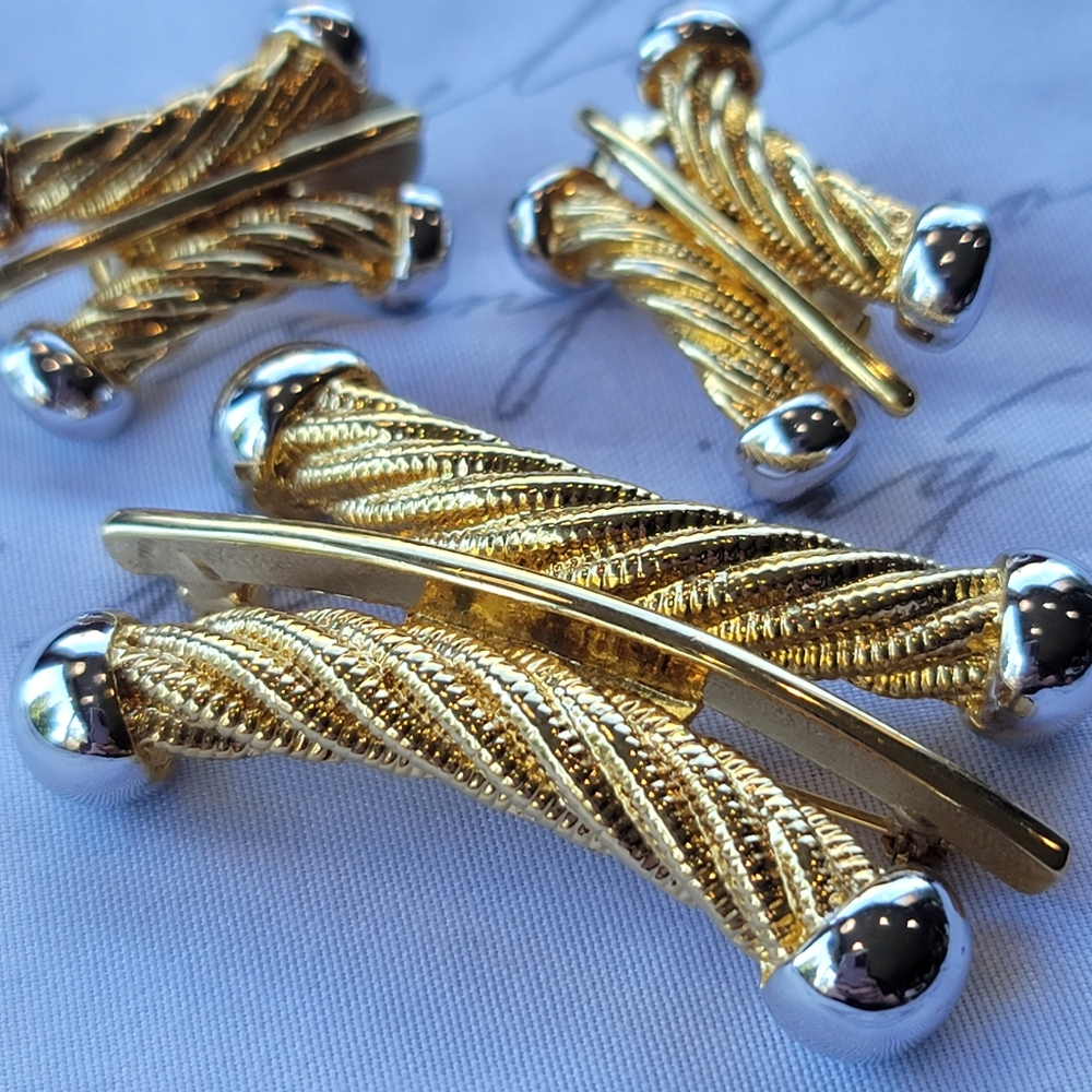 Vintage brooch and clip earring set gold w silver accents.